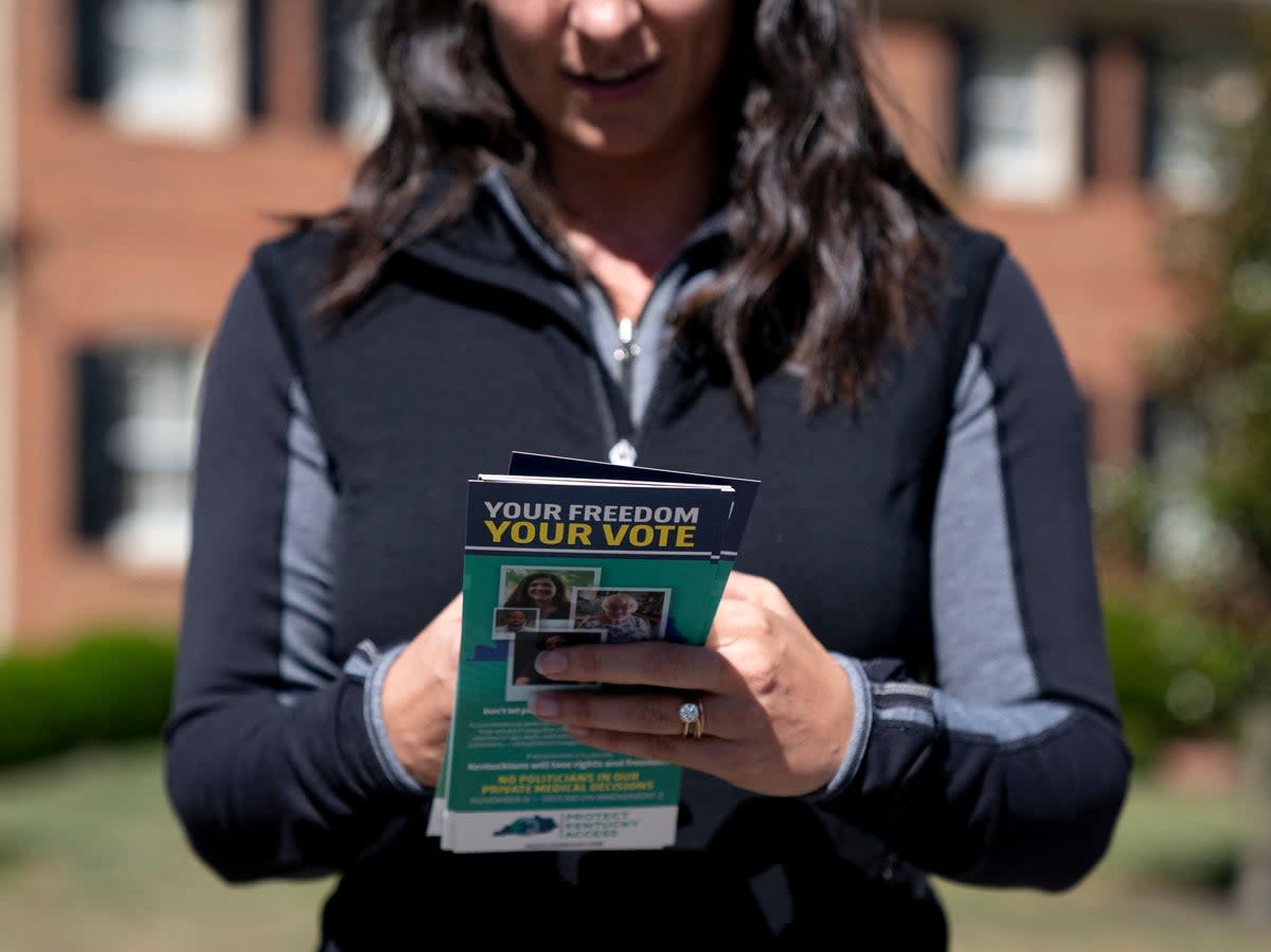 A woman carries brochures with information on Amendment 2 while volunteering with Protect Kentucky Access in Lexington, Kentucky, on 1 October 2022. Amendment 2, a proposed anti-abortion measure, was rejected in the midterms (AFP/Getty)