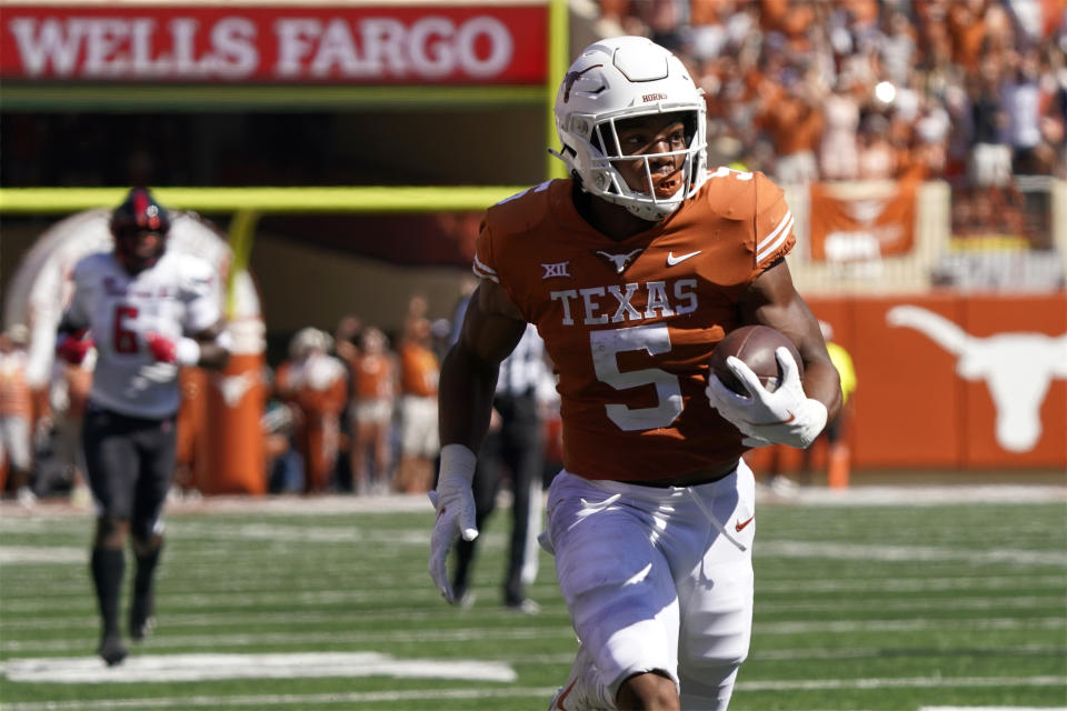 Texas running back Bijan Robinson (5) runs for a touchdown against Texas Tech during the first half of an NCAA college football game on Saturday, Sept. 25, 2021, in Austin, Texas. (AP Photo/Chuck Burton)