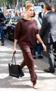 <p>The athleisure trend has been going strong for years now, but Hailey Baldwin seems to be taking it upon herself to subtly steer the fickle fashion masses in a new direction, by pairing her all-dark brown sweatsuit with rhinestone-encrusted heels for a look we're going to go ahead and dub "black tie couch potato."</p>
