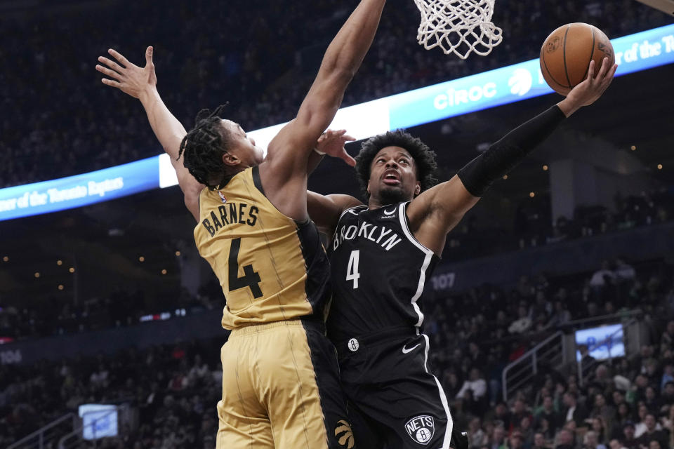 Brooklyn Nets' Dennis Smith Jr. shoots on Toronto Raptors' Scottie Barnes during the first half of an NBA basketball game in Toronto on Thursday, Feb. 22, 2024. (Chris Young/The Canadian Press via AP)