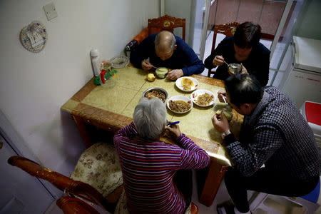 Jiang Weimao, 60, (R) and his wife Zhang Yinxiu, 53, have dinner with Zhang's parents at their house in Zhangjiakou, China, November 21, 2015. REUTERS/Kim Kyung-Hoon