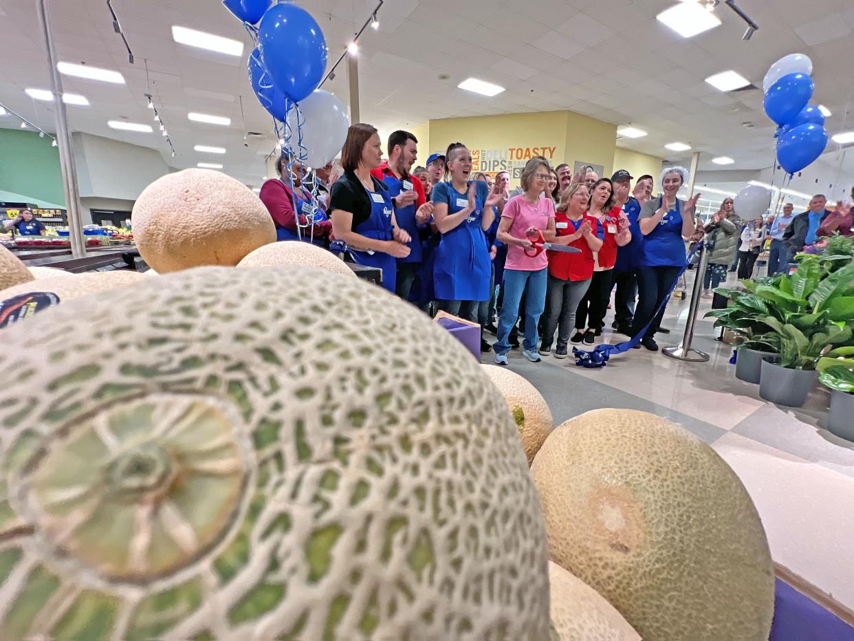 Joy Lillibridge-Norris cuts the ribbon Friday morning during the Ashland Road Kroger's Grand Re-opening ceremony.