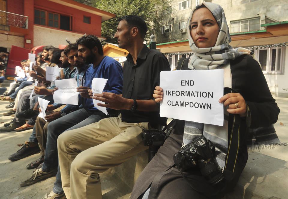 Kashmiri journalists display placards during a protest against the communication blackout in Srinagar, Indian controlled Kashmir, Thursday, Oct. 3, 2019. For the last two months, mobile phones and internet services have been shut down in the valley after New Delhi stripped Indian-controlled Kashmir of its semi-autonomous powers and implemented a strict clampdown, snapping communications networks, landlines and mobile Internet. (AP Photo/Mukhtar Khan)