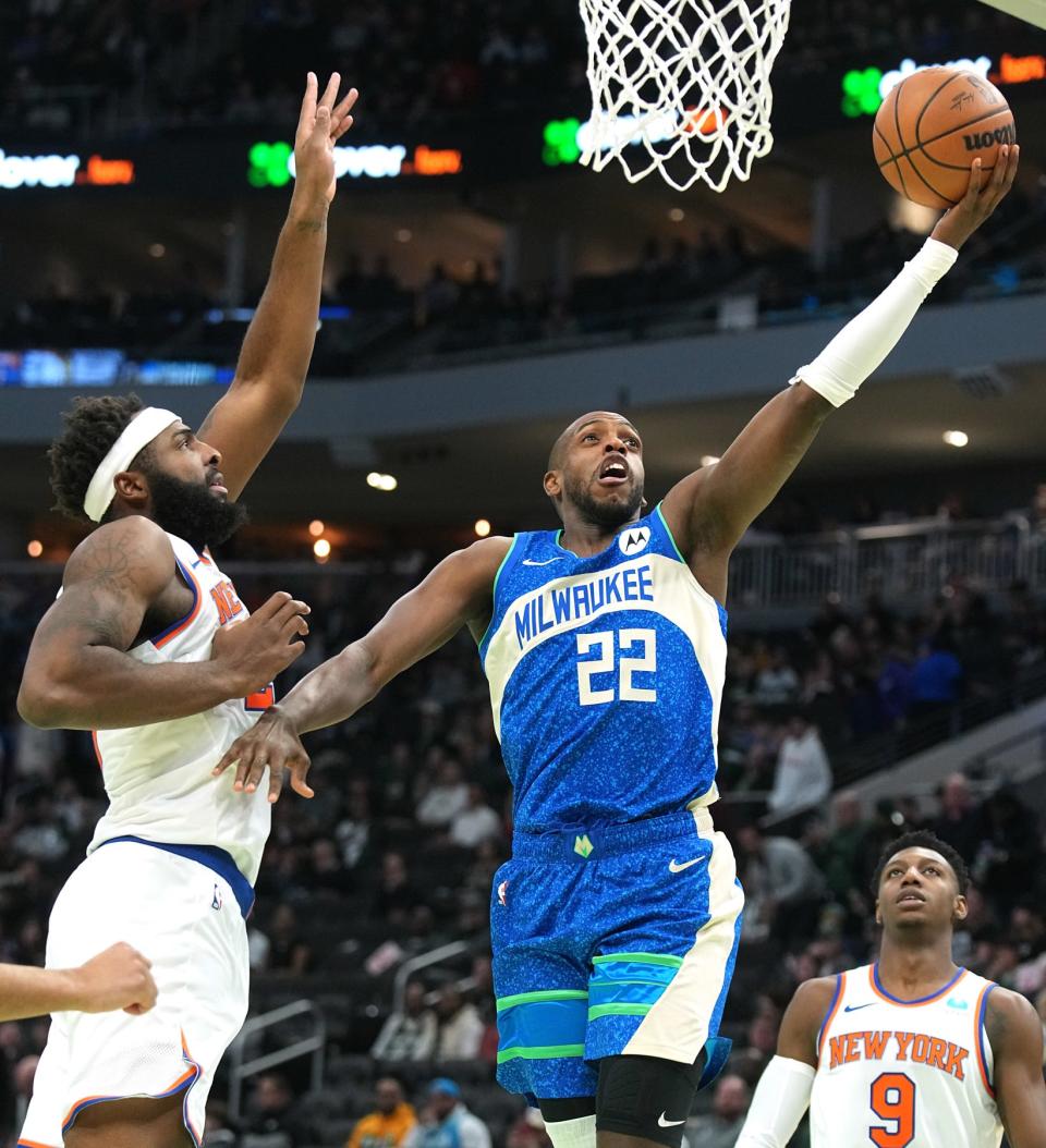 Milwaukee Bucks forward Khris Middleton scores on New York Knicks center Mitchell Robinson on Dec. 5, 2023 at Fiserv Forum.