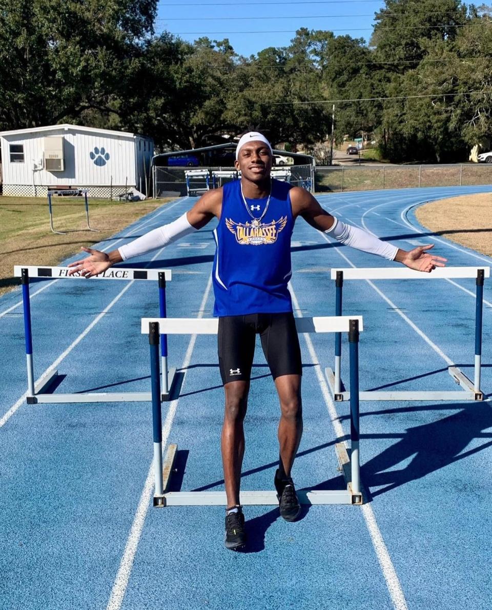 Tallahassee Community College men's track and field sophomore Troy Williams takes a photo in front of hurdles at Amos P. Godby High School in Tallahassee, Florida, Saturday, February 19, 2022