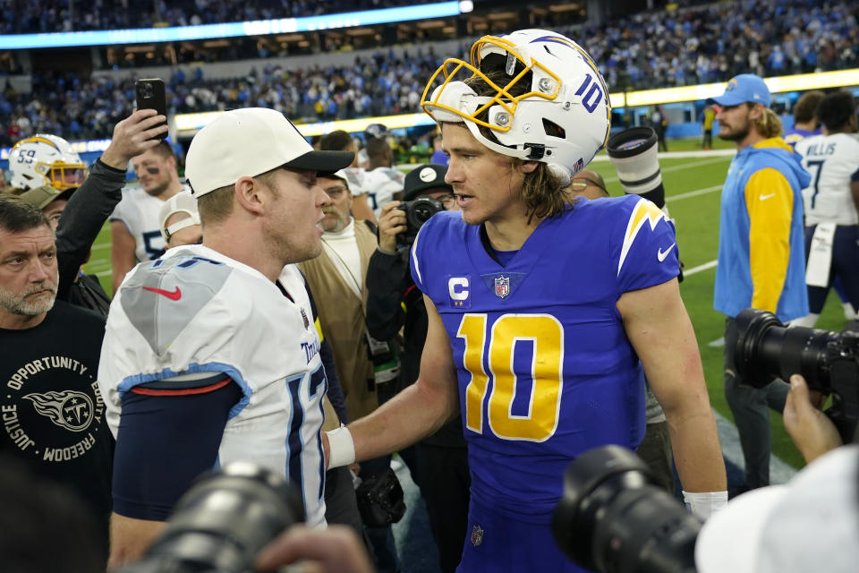 Tennessee Titans quarterback Ryan Tannehill, left, greets Los Angeles Chargers quarterback Justin Herbert (10) after an NFL football game in Inglewood, Calif., Sunday, Dec. 18, 2022. (AP Photo/Ashley Landis)