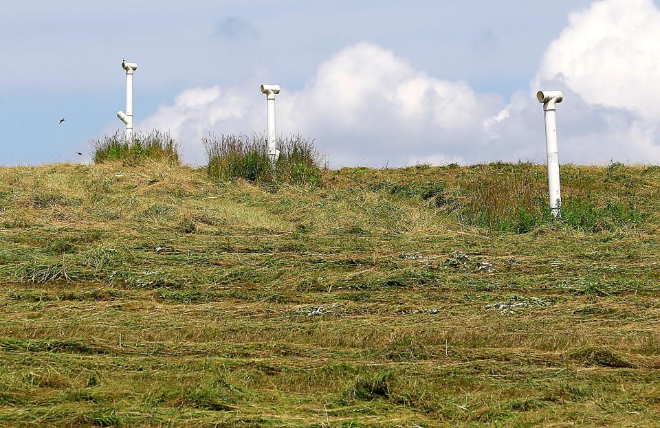 Vent pipes protrude from the ground at the old Ashland County Landfill site.