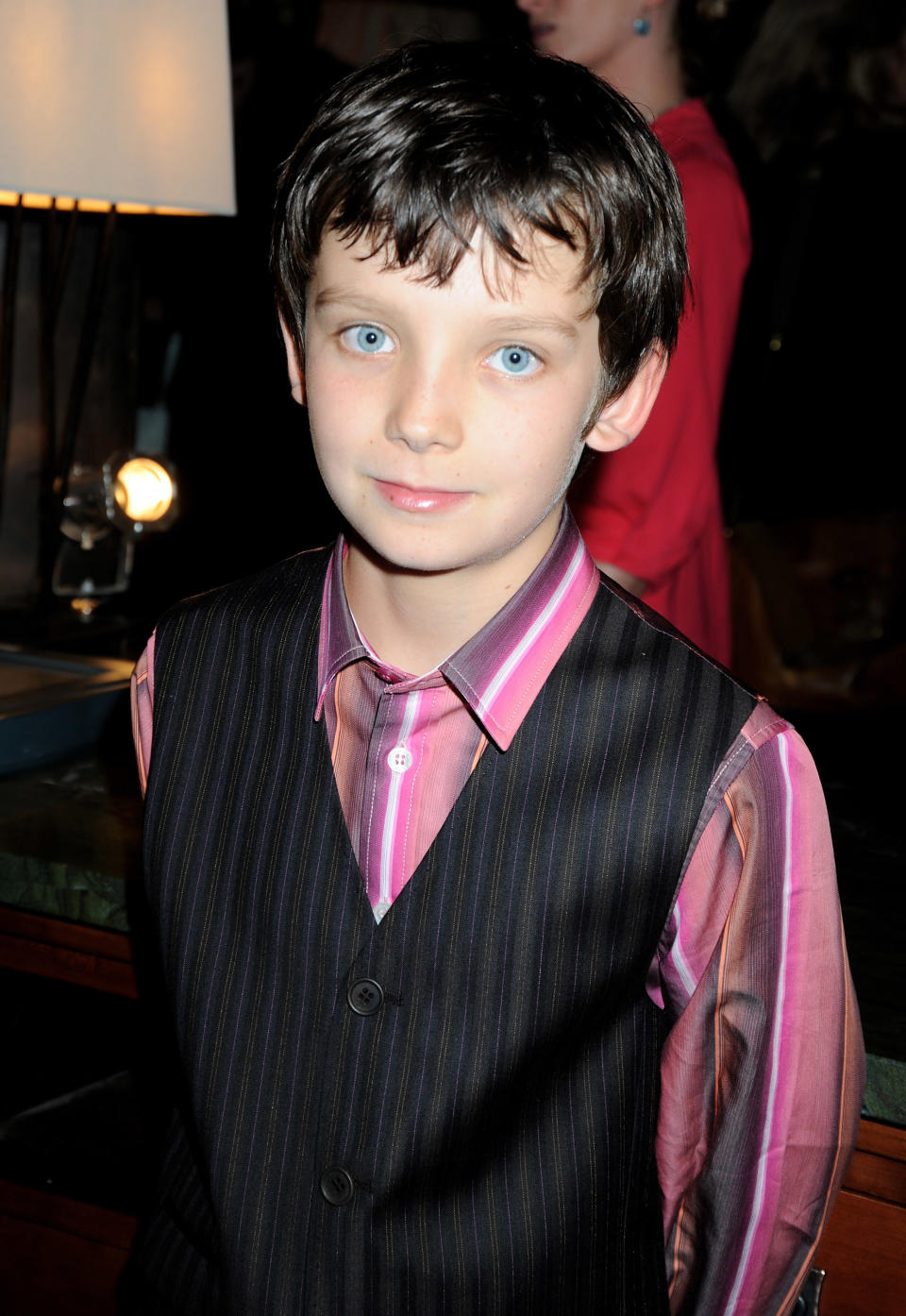 closeup of Asa in a suit vest