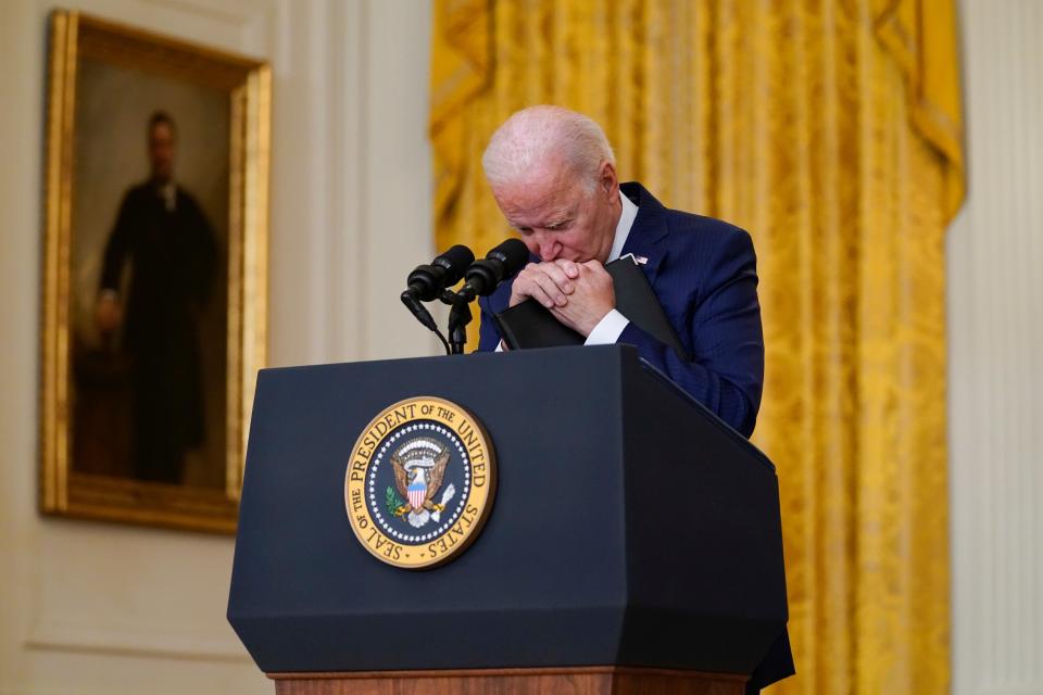 President Biden rest his head in his hands in apparent frustration during an exchange with Fox News reporter Peter Doocy (AP)