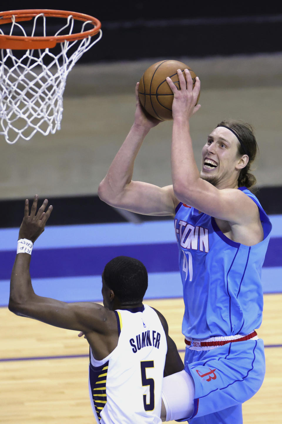 Houston Rockets' Kelly Olynyk drives to the basket over Indiana Pacers' Edmond Sumner during the third quarter of an NBA basketball game Wednesday, April 14, 2021, in Houston. (Carmen Mandato/Pool Photo via AP)