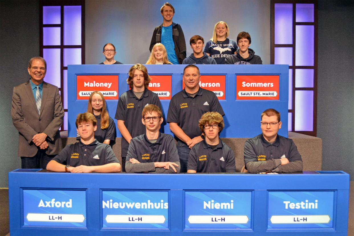 Representing Sault Ste. Marie (seated from left) are players Eleanor Maloney, Laura Krans, team captain Ryan Anderson and Nathaniel Sommers. Standing are alternate Patrick Smith and coach Kim Badenski. Players for Lake Linden-Hubbell are (seated from right) Trey Testini, Caiden Niemi, team captain Samuel Nieuwenhuis and Lukas Axford. Standing are alternates Sammy Blake and Danny Mikus with coach Andy Crouch. High School Bowl host Jim Koski is standing at lower left.