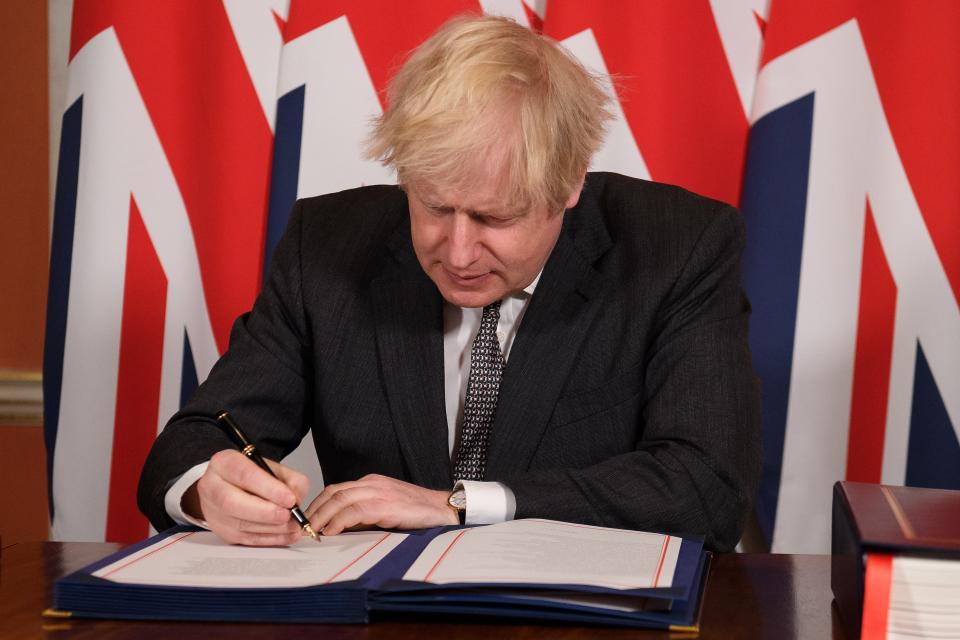 Boris Johnson signs his trade deal (Getty Images)
