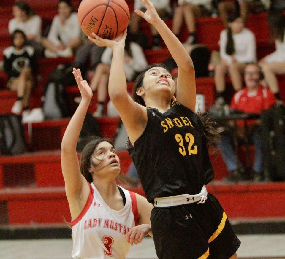 Snyder's Iverie Castillon shoots an inside shot while guarded by Sweetwater's Marissa Garcia on Tuesday, Jan. 18, 2022.