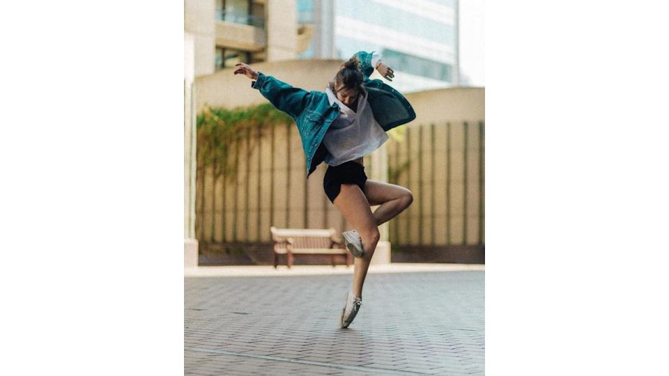 Woman dancing in a jacket 