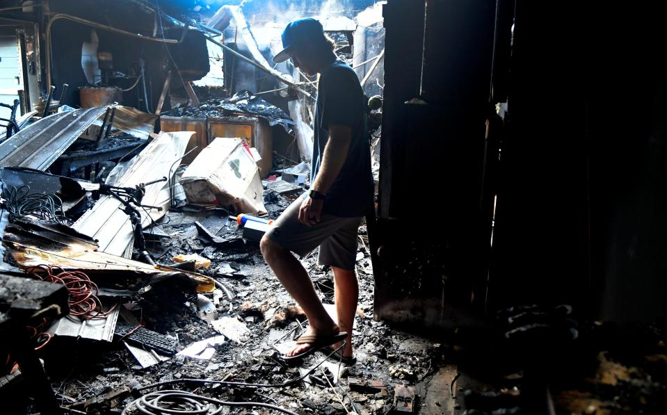 Blake Lott stands inside the blackened interior of his family's Magnolia Avenue home on New Year's Day in Melbourne Beach.