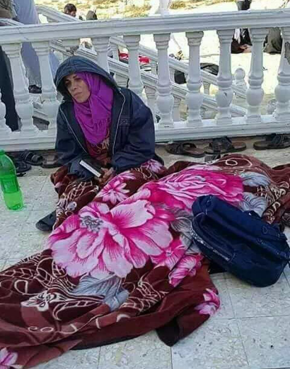 <p>An Egyptian woman whose husband was injured in an attack on al-Rawda mosque one day earlier, reads from the Quran after learning that he had just passed away, at hospital in the town of Bir al-Abed, some 40 km from Arish, Northern Sinai, Egypt, 25 Nov. 25, 2017. (Photo: STR/EPA-EFE/REX/Shutterstock) </p>