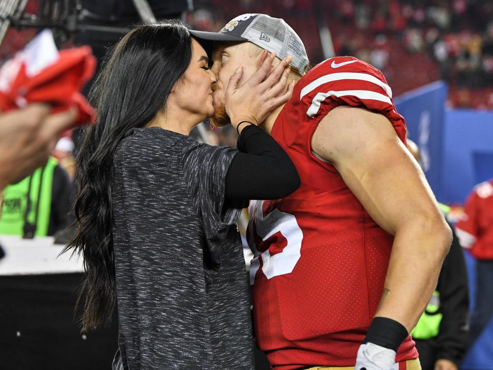 George Kittle (85) victorious, kissing wife Claire after winning game vs Green Bay Packers at Levi's Stadium. Santa Clara, CA