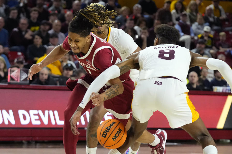 Stanford Cardinal guard Kanaan Carlyle, left, gets fouled by Arizona State forward Alonzo Gaffney (8) during the first half of an NCAA college basketball game Thursday, Feb. 1, 2024, in Tempe, Ariz. (AP Photo/Ross D. Franklin)