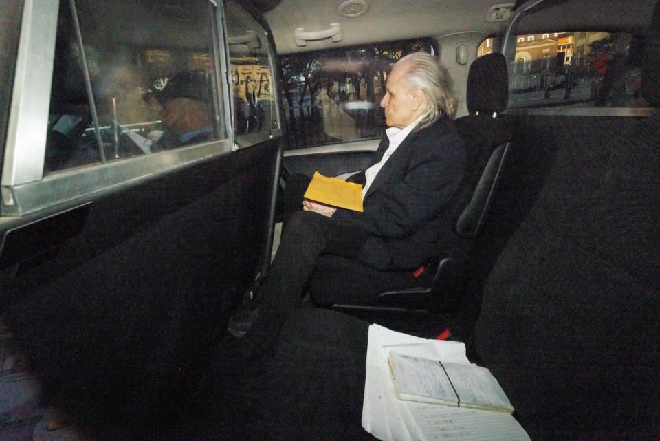 Seen through a police vehicle window, Peter Nygard arrives to a Toronto courthouse on Tuesday, Oct. 3, 2023, ahead of the continuation of his sexual assault trial.
