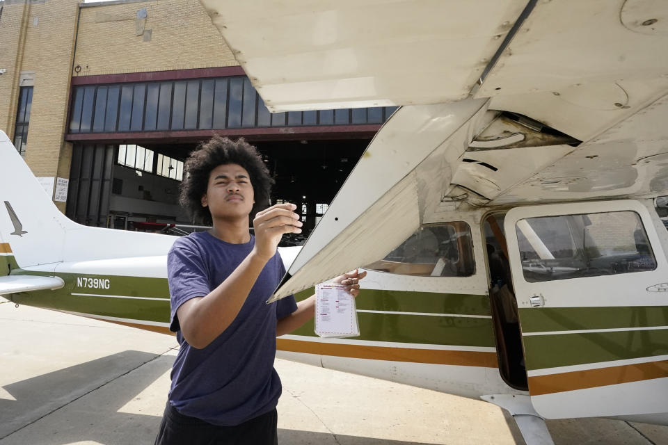 Kyan Bovee goes through a preflight check, Tuesday, Sept. 5, 2023, at the Coleman A. Young airport in Detroit. The Detroit teen is part of a program that teaches young people how to fly, while exposing them to careers in aviation and as pilots...areas people of color traditionally are underrepresented. (AP Photo/Carlos Osorio)