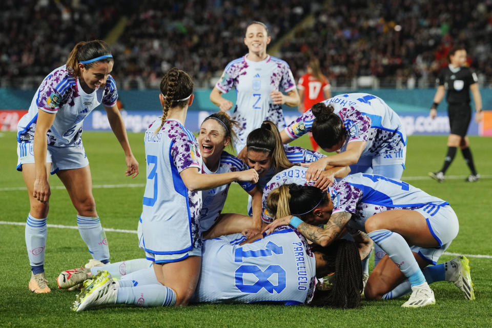 Spain's Laia Codina, obscured, is congratulated bye teammates after scoring her team's fourth goal during the Women's World Cup second round soccer match between Switzerland and Spain at Eden Park in Auckland, New Zealand, Saturday, Aug. 5, 2023. (AP Photo/Abbie Parr)