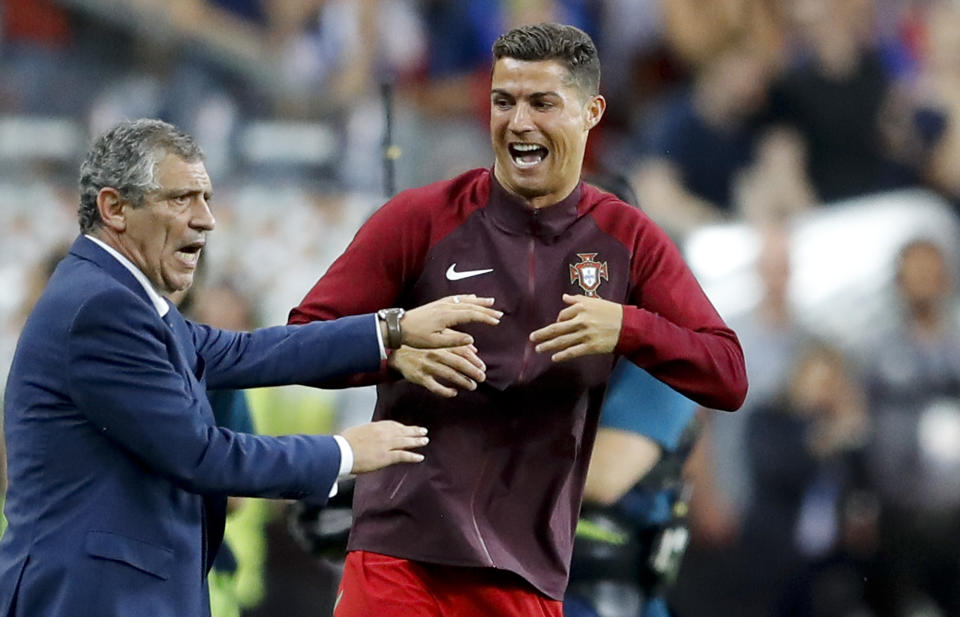 FILE - Portugal's Cristiano Ronaldo and Portugal coach Fernando Santos react moments before the end of the Euro 2016 final soccer match between Portugal and France at the Stade de France in Saint-Denis, north of Paris, on July 10, 2016. The last 32-team World Cup will be the shortest in this era. There are just 28 days from starting on Nov. 21 in Qatar to finishing on Dec. 18. And only 25 days to play seven games if a team from Groups G or H – like Brazil or Portugal – is to reach the final after opening on Nov. 24. (AP Photo/Frank Augstein, File)