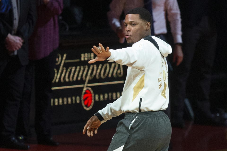 Toronto Raptors' Kyle Lowry looks at the NBA championship ring he had received before the team's NBA basketball game against the New Orleans Pelicans on Tuesday, Oct. 22, 2019, in Toronto. (Chris Young/The Canadian Press via AP)