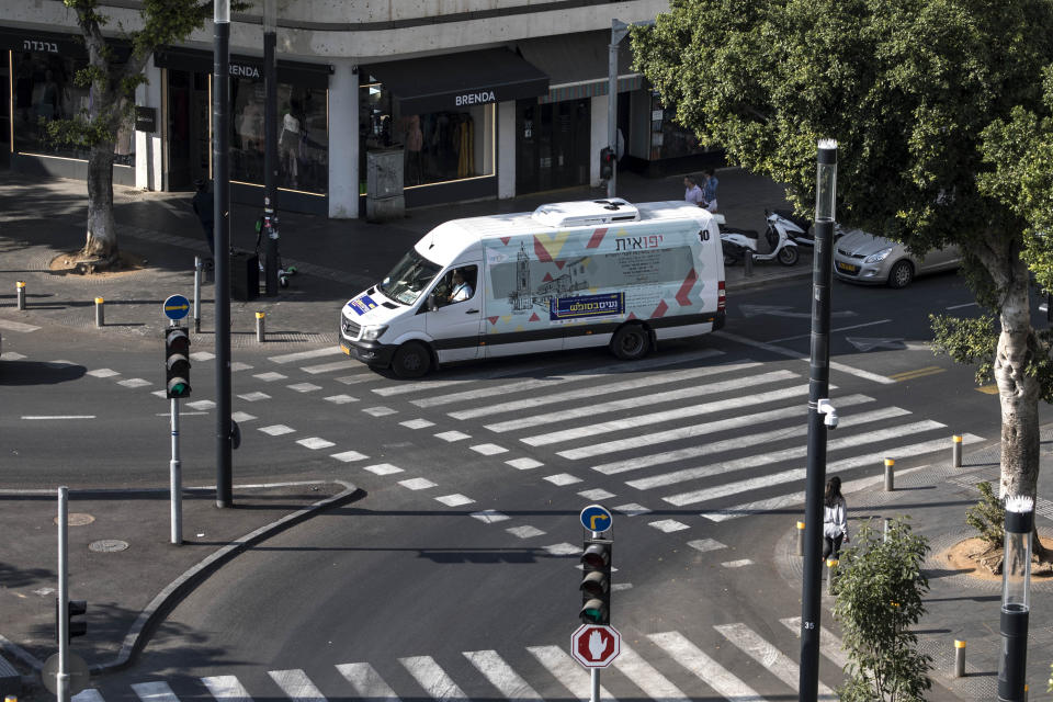 In this photo made on Saturday, Nov. 23, 2019, first ever public bus operated on Shabbat, drives through central Tel Aviv, Israel. Tel Aviv has taken a major step to cement its status as Israel's secular mecca, launching a public transit system operating on Saturdays and redrawing the lines in the Jewish state's culture wars between religious and secular citizens. (AP Photo/Tsafrir Abayov)