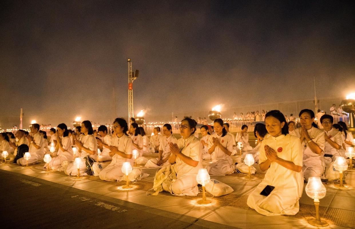 <span class="caption">Most religions emphasize rest and contemplation.</span> <span class="attribution"><a class="link " href="https://www.gettyimages.com/detail/news-photo/devotees-seen-meditating-with-their-lanterns-during-the-news-photo/1125915288?adppopup=true" rel="nofollow noopener" target="_blank" data-ylk="slk:Geovien So/SOPA Images/LightRocket via Getty Images;elm:context_link;itc:0;sec:content-canvas">Geovien So/SOPA Images/LightRocket via Getty Images</a></span>