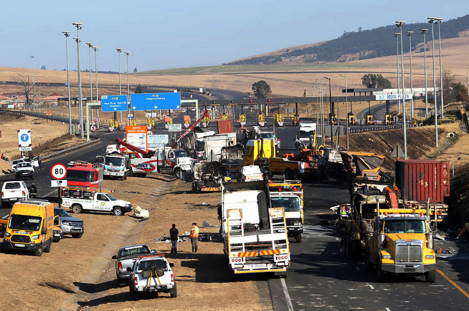 A section of a main freeway, at the Mooi River Plaza in the KwaZulu-Natal Province, South Africa, is blocked off, Saturday, July 10, 2021 after trucks were set alight in overnight protests by supporters of former South African president Jacob Zuma who was imprisoned this week for contempt of court. The protesters are demanding that Zuma be released from prison immediately. (AP Photo)