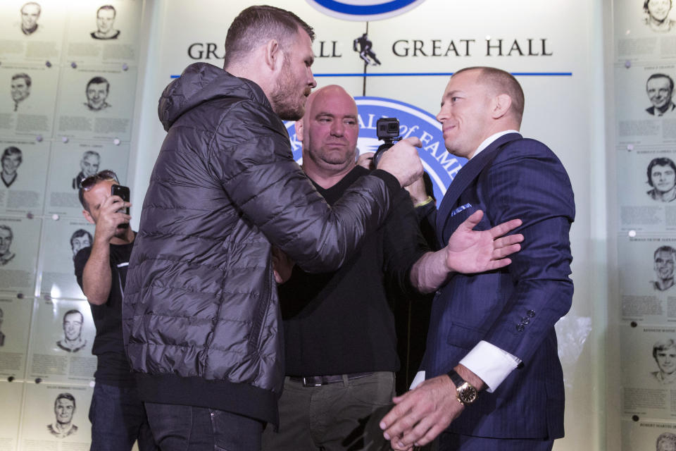 Michael Bisping, left, and Georges St-Pierre face off during a news conference to promote their upcoming UFC 217 fight. (AP)