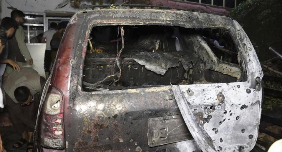 A destroyed vehicle inside a home after the airstrike. Source: AP