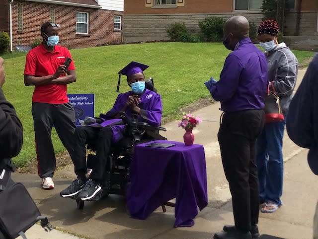 Davenport presents a student with his diploma in front of his home in Cincinnati (Photo: Ramone Davenport)