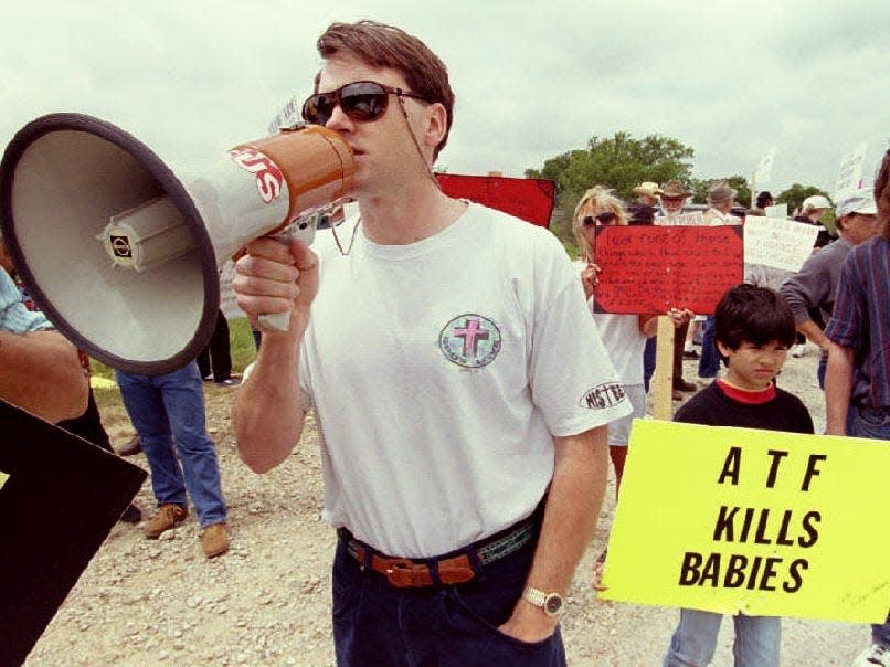 A protester uses a bullhorn to lead protesters in an anti-ATF demonstration at the checkpoint leading to the remains of the Branch Davidian cult compound