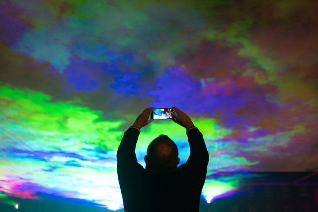 People view ‘Borealis’ a laser light art installation by Dan Acher