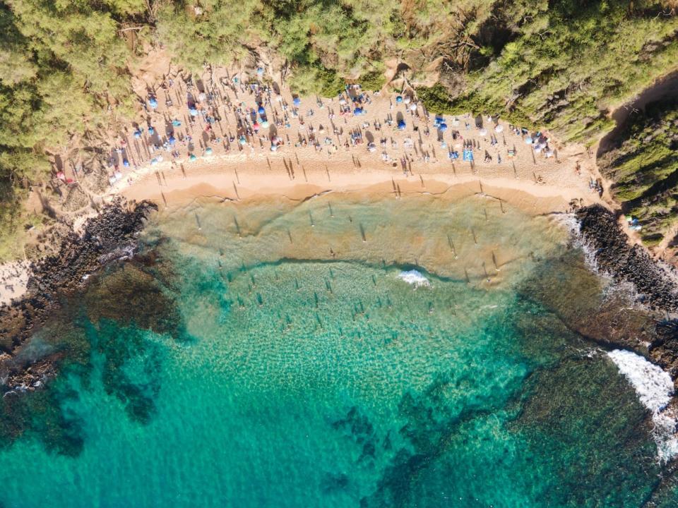 PHOTO: A crowd of tourists visit Little Beach in Maui, HI, in an undated photo. (M Swiet Productions/Getty Images)