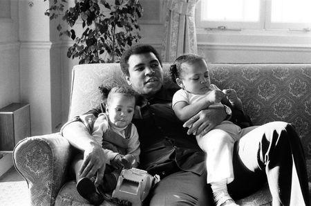 Muhammad Ali cuddling his daughters Laila, (L ) and Hana at a hotel in London, December 1978. Action Images / MSI/File Photo