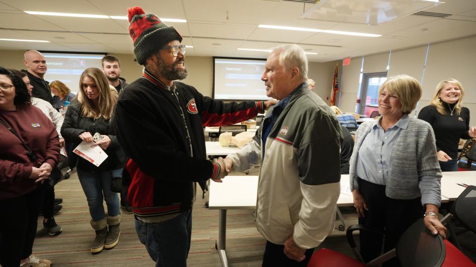 Roosters manager Carlos Bennett (left) says thanks to Roosters founders Bob and Corrine Frick after an automated external defibrillator training session held at The Ohio State University Wexner Medical Center Wednesday, Jan. 3, 2024. The Fricks are buying an AED for each of their 15 corporate restaurants and Bennett was one of the managers trained in their use. Bennett is a manager at the Huber Heights location.