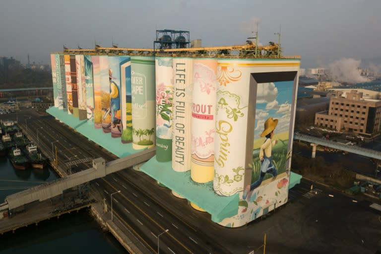 The painting which depicts a young boy's childhood covers the outside of giant storage containers in the port city of Incheon, west of Seoul