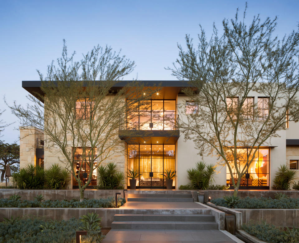 <p> California-based designer Kendall Wilkinson made the most of the sloped front yard on this Monte Sereno property with raised flower beds. </p> <p> 'We wanted to highlight the grand entrance with varying levels of plantings to draw your eye up and usher you into this amazing home with a water feature and a mix of cement and stone in grey tones,' Kendall explains.  </p> <p> 'It's always important to partner with a landscape designer whose work complements the architecture and interior design, utilizing regional plants and mixing varying heights and textures.' </p>