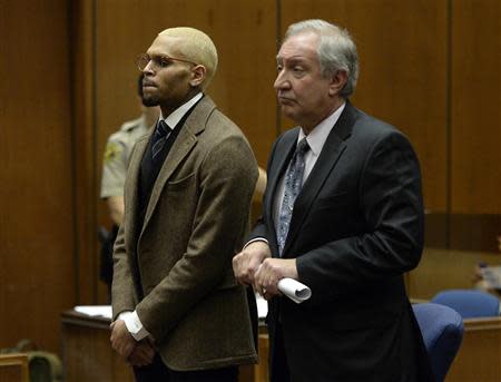 Singer Chris Brown (L) and his attorney Mark Geragos appear in court during a probation violation hearing in which his probation was revoked in Los Angeles Superior Court in Los Angeles, December 16, 2013. REUTERS/ Kevork Djansezian/Pool