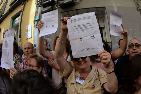 Protestors chant and hold up ballot papers with the proposed question for a referendum on breaking away from Spain during a rally in favour of a planned referendum on the independence of Catalonia in Madrid, Spain, September 17, 2017. REUTERS/Sergio Perez