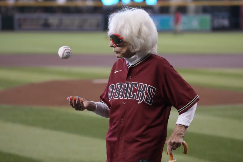 Former All American Girls Professional Baseball player Maybelle Blair tosses a ball in the air