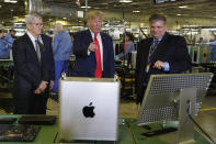 President Donald Trump tours an Apple manufacturing plant, Wednesday, Nov. 20, 2019, in Austin with Apple CEO Tim Cook, left. (AP Photo/ Evan Vucci)