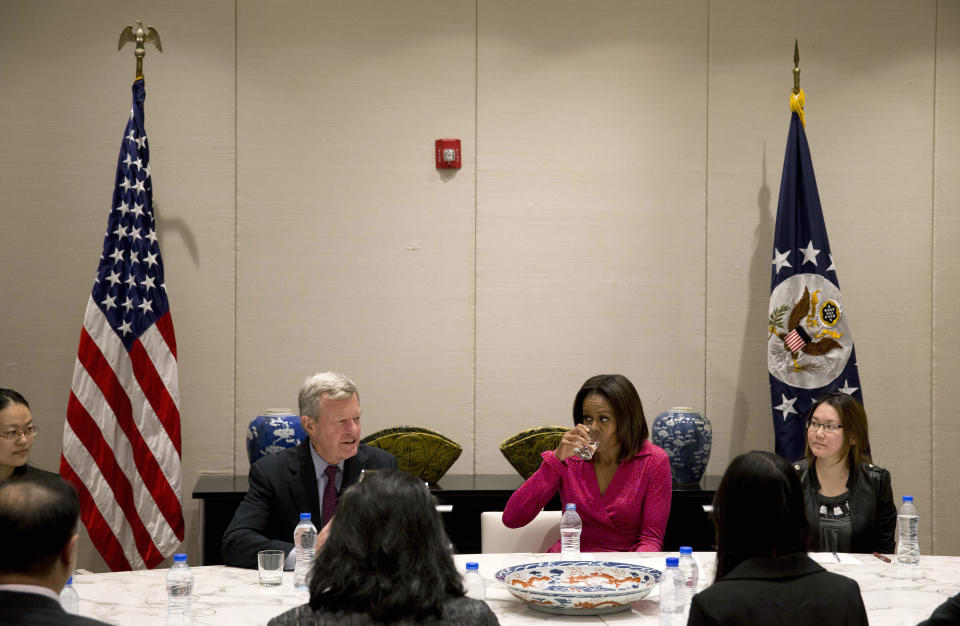 U.S. first lady Michelle Obama, center right, drinks water as U.S. Ambassador to China Max Baucus, center left, speaks during a round table discussion on education at the U.S. Embassy in Beijing, China Sunday, March 23, 2014. (AP Photo/Andy Wong)
