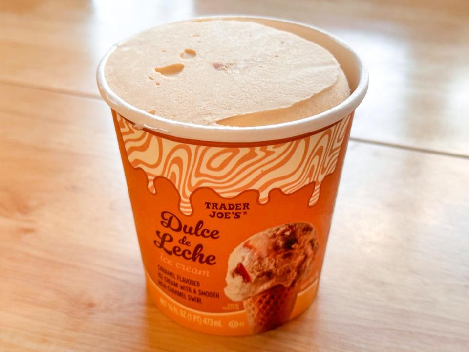 An orange pint of ice cream with a tan and cream zebra-print design on the packaging. The ice cream is open, revealing a smooth light-brown ice cream