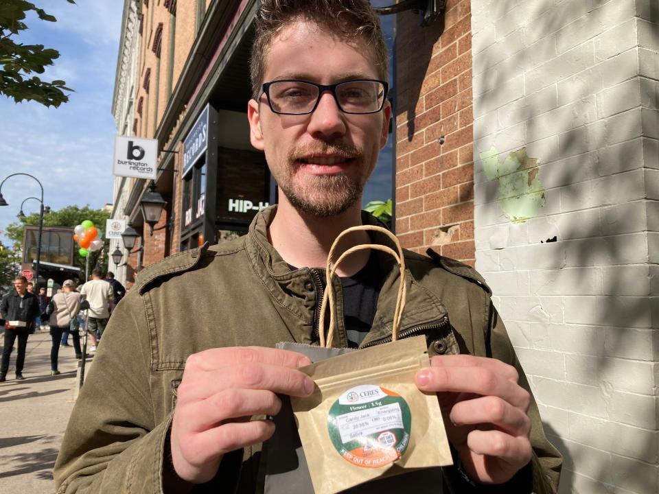 Brandon Coburn, of St. Albans, Vt., holds his purchase – an eighth of an ounce of cannabis flower – on Saturday near the Ceres Collaborative store in Burlington on the first day of retail adult-use cannabis sales in Vermont.