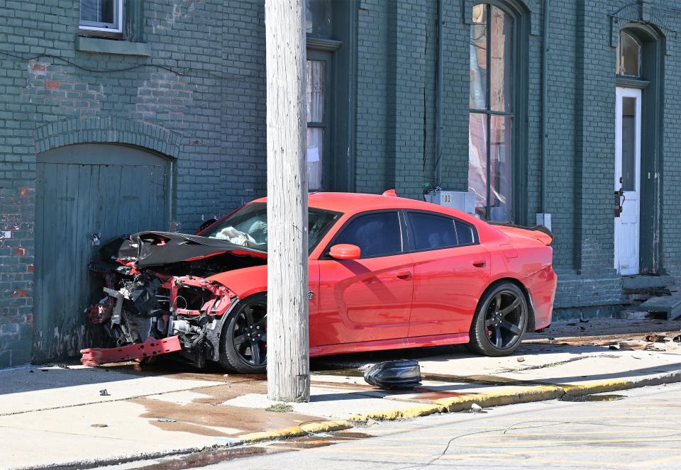 The Dodge Charger Hellcat smashed into the side of this building Sunday and slid along the brick wall after it failed to make a turn off U.S. 12 fleeing police