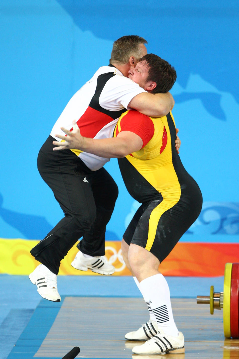 BEIJING - AUGUST 19: Matthias Steiner of Germany celebrates winning the gold medal in the Men's 105 kg group weightlifting event with his coach Frank Mantek at the Beijing University of Aeronautics & Astronautics Gymnasium on Day 11 of the Beijing 2008 Olympic Games on August 19, 2008 in Beijing, China. (Photo by Julian Finney/Getty Images)