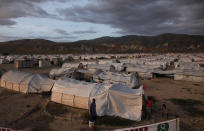 <p>Earthquake victims sheltered at Camp Corail, a provisional camp about 12 miles (20 km) north of Port-au-Prince, walk among their tents November 1, 2010. (Photo: Eduardo Munoz/Reuters) </p>